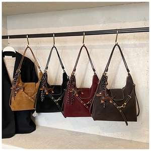 Detail of suede tote bags in four colors with decorative dachshund charms