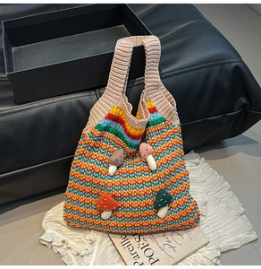 Detail of colorful crochet tote bag featuring 3D plush mushroom accents and wave knit patterns