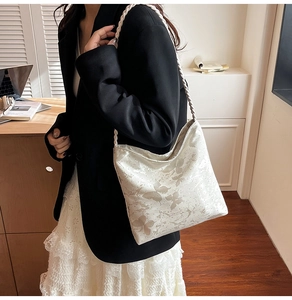 Detail of off-white tote bag with floral print and unique braided shoulder strap