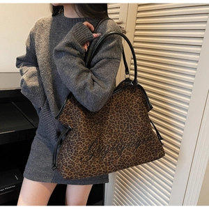 Detail of large leopard print tote bag with black cursive embroidery and drawstring side