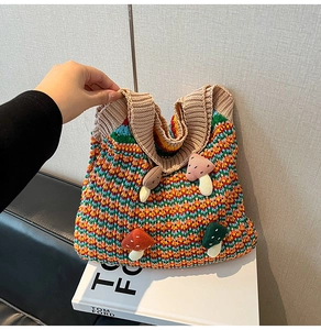 Detail view of colorful crochet tote bag with rainbow knit texture and 3D mushroom patches