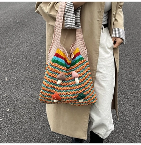 Close-up of handmade rainbow crochet tote bag with colorful 3D mushroom applique detail