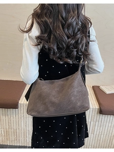Model wearing dark brown vintage hobo bag with textured matte finish for daily commute