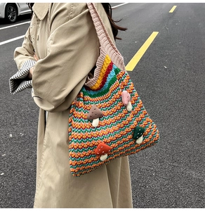 Detail of colorful knitted tote bag with 3D mushroom patches and wave pattern texture
