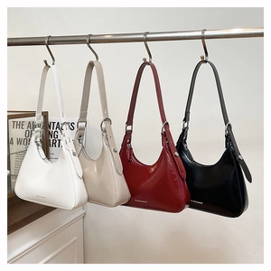Hobo bags in four colors hanging on a metal rod featuring a minimalist glossy finish
