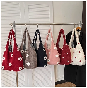 Detailed view of knitted tote bags in six colors with flower patterns and checkered lining