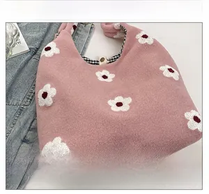 Pink plush tote bag detail showing the floral pattern, checkered lining, and magnetic buckle