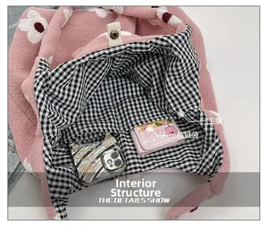 Pink plush tote bag interior showing the main compartment and zipper pocket with floral print
