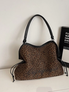 Large leopard print canvas tote bag with black leather handles and drawstring side details