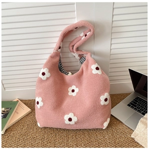 Pink floral plush tote bag detail with black and white checkered lining and soft texture