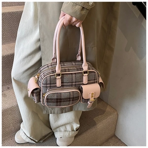 Détail du cabas à carreaux vintage avec finitions en cuir rose et poches à fermeture