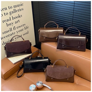 Detail view of retro aesthetic matte and gloss mini square handbags on a leather sofa