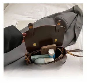 Detail view of the interior capacity of this vintage dark brown crossbody bag for women