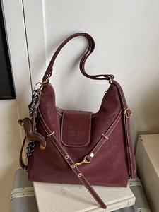 Vintage burgundy leather hobo bag with contrast stitching and cute puppy pendant accessory