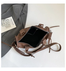 Detail of brown faux leather Boston bag interior showing spacious lining and pockets