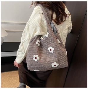 Detail of plush flower tote bag in brown knit with contrast checkerboard lining