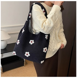 Detail of plush flower tote bag showing inner checkered lining and magnetic closure