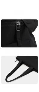 Close-up of black waterproof tote bag featuring smooth metal zippers and reinforced handles