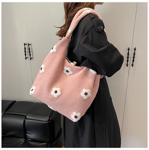 Detail of pink floral tote bag showing warm wool-like texture and plaid inner lining