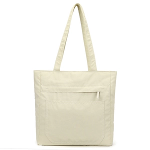 Detail of light beige waterproof nylon tote bag showing its micro-grid texture and zipper pocket