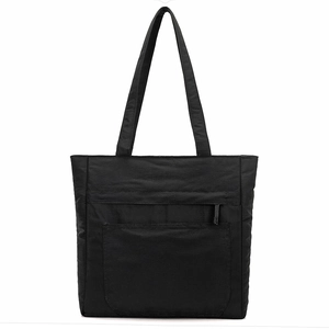 Close-up of black nylon tote bag with front zipper pocket and fine textured fabric
