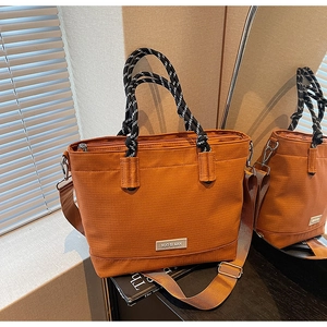 Détail du sac cabas orange en tissu Oxford avec anses tressées et bandoulière
