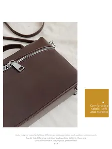 Detail view of brown matte shoulder bag featuring a silver metal zipper and rectangular puller