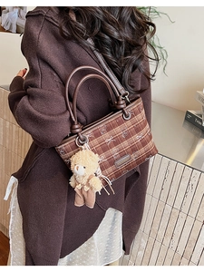 Brown checkered bucket bag with bear charm detail and leather handles for women