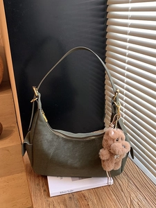 Olive green half-moon crossbody bag in matte leather with cute plush bear charm