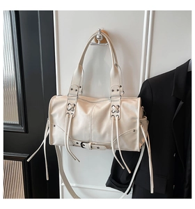 Detail of off-white wasteland style boston bag with lace-up fringes and silver buckles