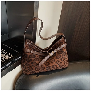 Detail of vintage brown leopard print suede shoulder bag with gold metal buckle