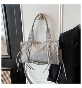 Detail of gray matte faux leather boston bag with retro biker straps and buckles