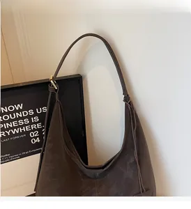 Detail of the vintage dark brown hobo bag showing its premium matte leather texture