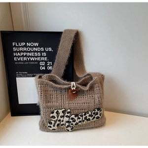 Close-up of knit tote bag featuring a brown mohair texture and a leopard Mama patch