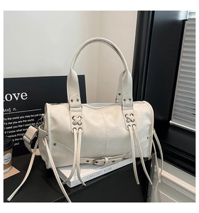 Detail of off-white wasteland style Boston bag with fringe tassels and metal studs