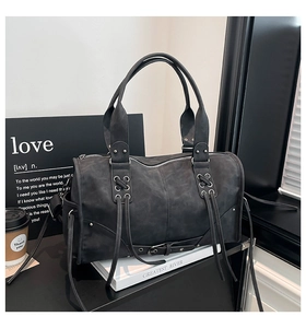 Detail of dark gray retro washed leather tote with studs and cross straps decoration