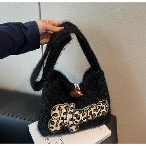 Detail of black fuzzy knit tote bag featuring leopard print Mama applique and leather buckle