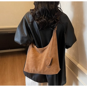 Brown faux suede tote bag with decorative side pouch and center seam detail shown from back