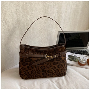 Close-up of leopard print shoulder bag with fuzzy texture and golden hardware details