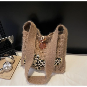 Detail of khaki knit tote bag showing fluffy mohair texture and leopard letter patch