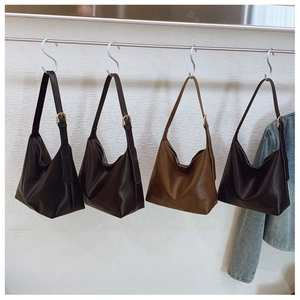 Detail view of four textured leather hobo bags with adjustable buckles in various colors