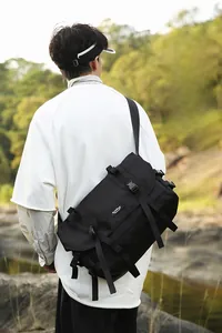 Detailed view of the black waterproof nylon messenger bag with adjustable straps and buckles