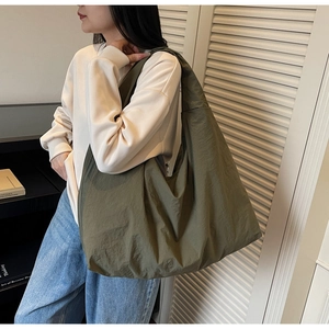 Army green large capacity tote bag shown on shoulder for casual daily style