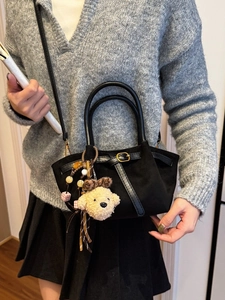 Retro black canvas handbag with leather trim and a cute plush puppy charm