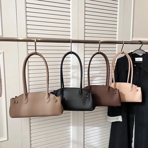 Litchi pattern baguette bags shown in four classic colors on a white door backdrop