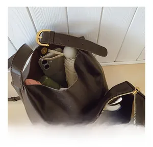 Deep brown bucket bag interior view showing large storage capacity for daily essentials
