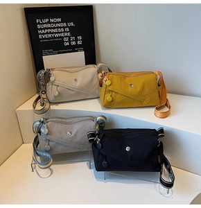 Detail view of nylon crossbody bags in four colors with adjustable jacquard straps