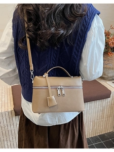 Khaki large capacity crossbody bag with lychee texture leather shown on a model
