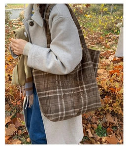 Detail of vintage brown plaid tote bag with A/H 1991 LUCKY embroidery on checkered fabric