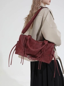 Vintage burgundy leather motorcycle tote bag with tassels and silver metal hardware details